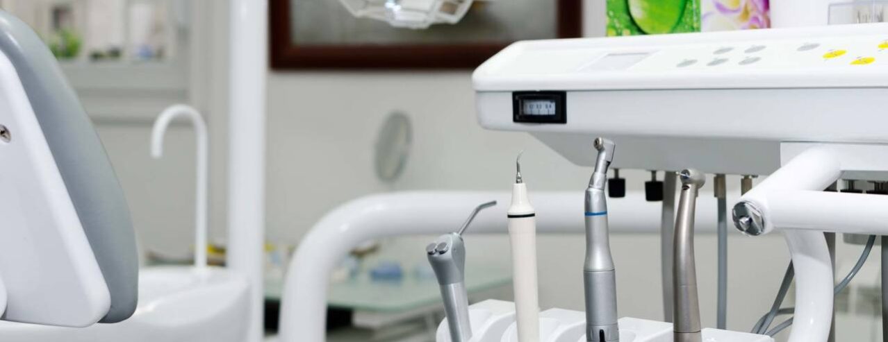 Dental tools next to a dental chair